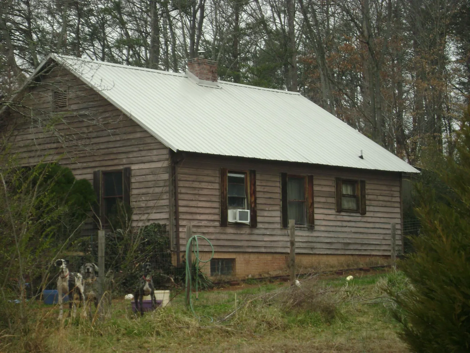 White metal roof on an old wood sided farmhouse, from a Metal Roof Installation job in East Hanover